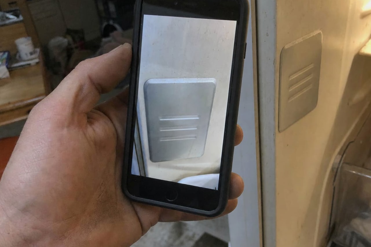 Model and serial plate on the upper interior wall of a Sub-Zero built-in refrigerator, photographed with a phone